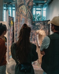 a group of people looking at art in a museum